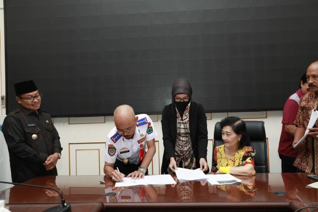 Kepala Dinas Perhubungan Kota Malang, R Wijaya Saleh Putra menandatangani akta jual beli tanah dengan pemilik tanah, Lisa. Penandatangan disaksikan Walikota Malang, H Sutiaji (ist)