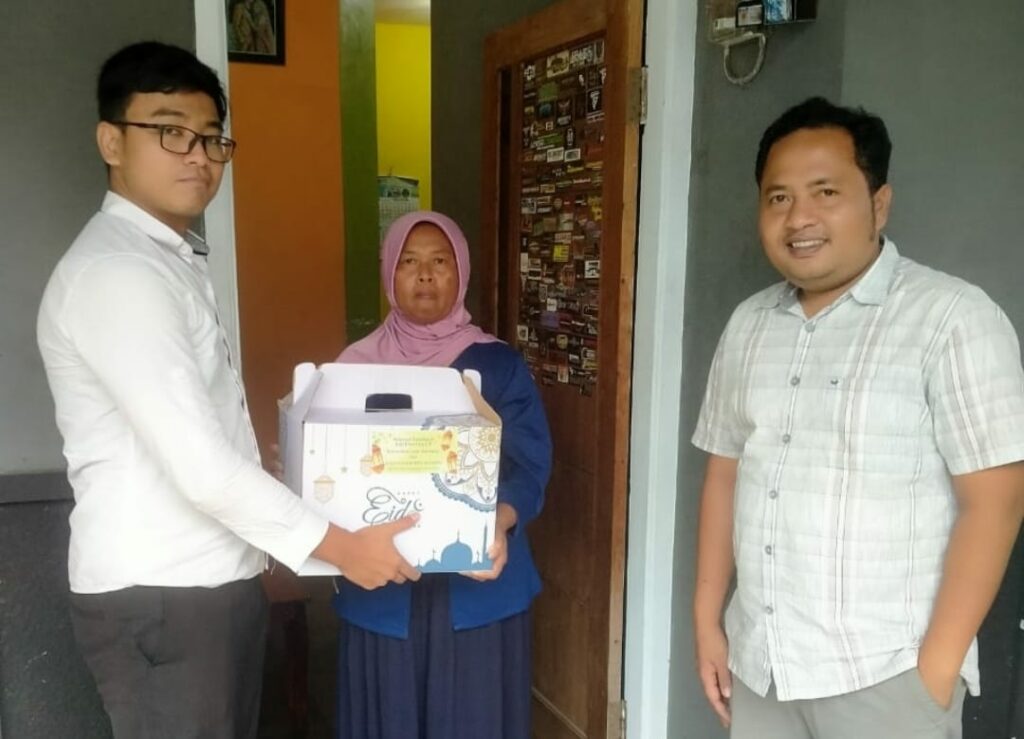 Foto anggota Satreskrim Polres Batu ketika memberikan paket Sembako kepada salahsatu keluarga TSK