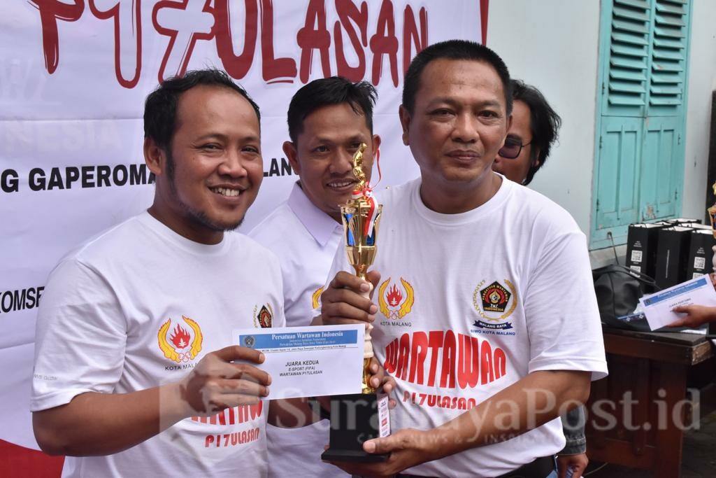 Ketua PWI Malang Raya, Cahyono menyerahkan trophy dan dana pembinaan kepada salah satu juara