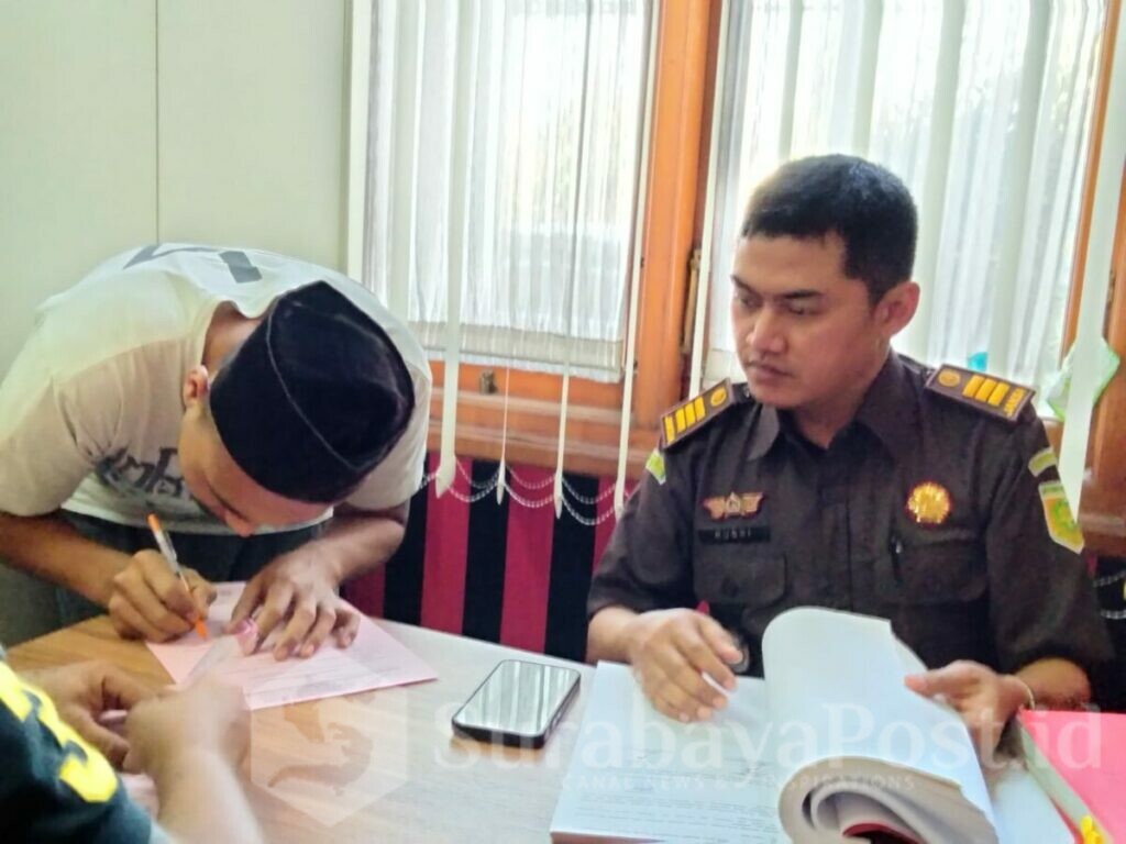 Salah satu tersangka menandatangani berkas pelimpahan disaksikan JPU Rusdianto Hadi Sarosa SH, MH