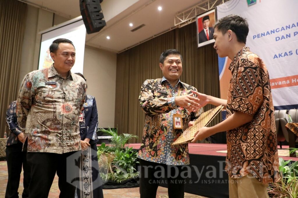 Kepala Disdikbud Kota Malang, Suwarjana menyalami salah satu anak yang kembali ke sekolah (Sumber Prokompim)