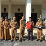 Walikota Malang, Dr. Ir. Wahyu Hidayat, MM, menyerahkan piagam penghargaan dan piala kepada para pemenang Lomba Kampung Mbois, Senin 5 Mei 2025. Sumber Prokompim).
