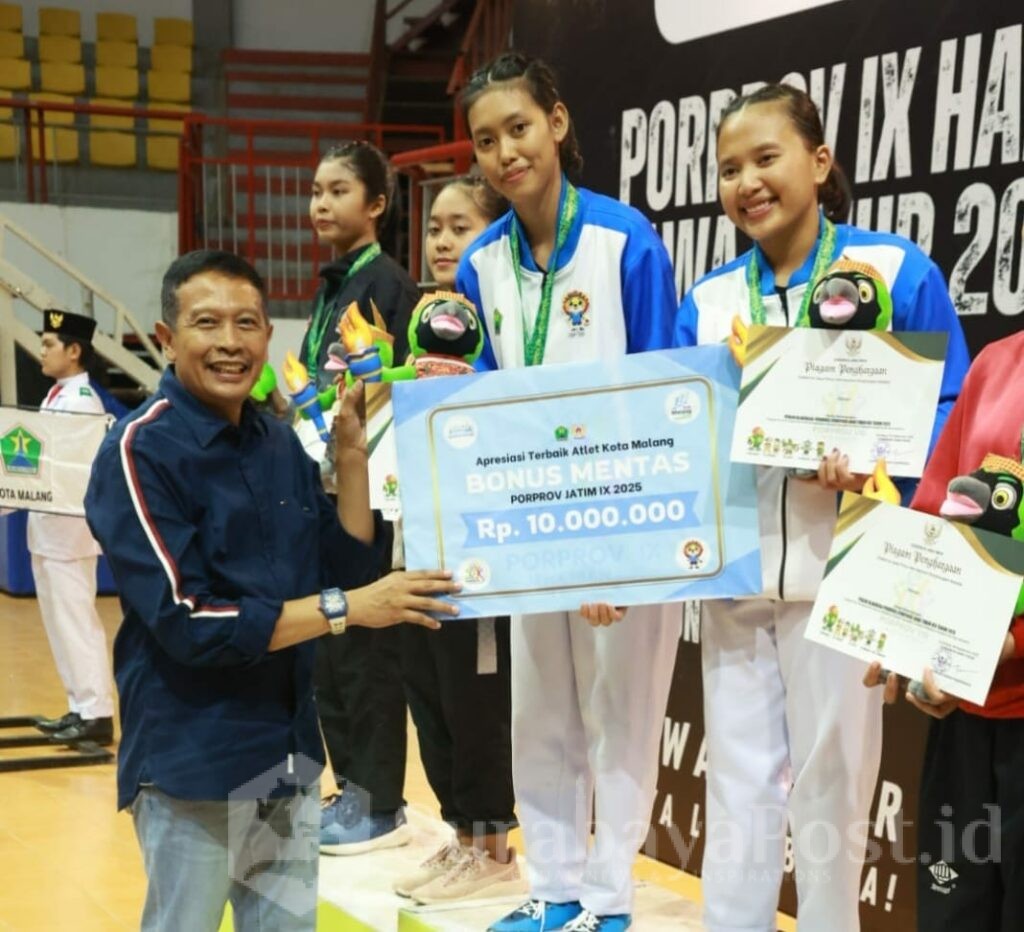 Walikota Wahyu Hidayat mengalungkan medali emas pada para juara hapkido dari Kontingen Kota Malang. (Sumber Prokompim)