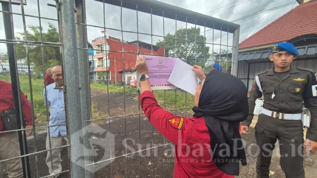 Tim penyidik Kejati Jatim saat melakukan penyitaan aset tugas bidang tanah dengan melakukan pemasangan plang. (Dok. Kejari).